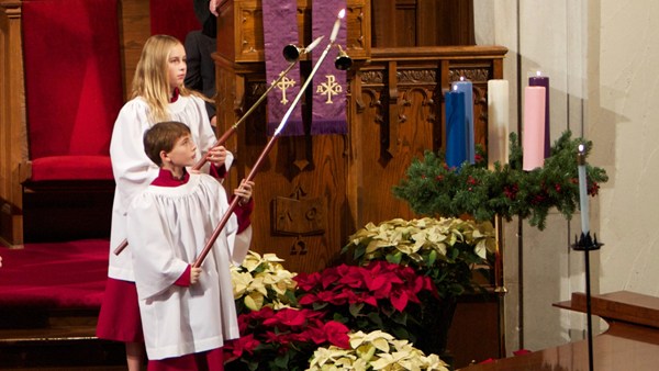 An image of youths lighting candles in acolyte garments