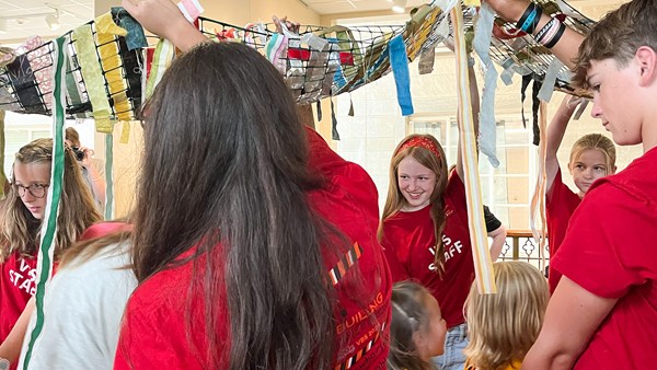 An image of an activity of volunteers and children